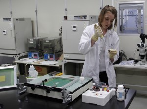 Research Fellow Ludmila Cojocaru from France demonstrating the production of a dye-sensitized solar cell.