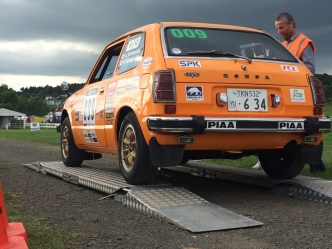 An orange Civic being prepared for the race