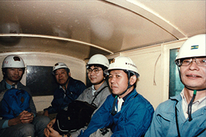 Takaaki Kajita with Professor Koshiba and other colleagues on a minecart in the Kamioka Mine, when Kamiokande was under construction