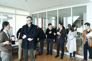 Attendees and professors enjoying friendly conversation during the coffee break
