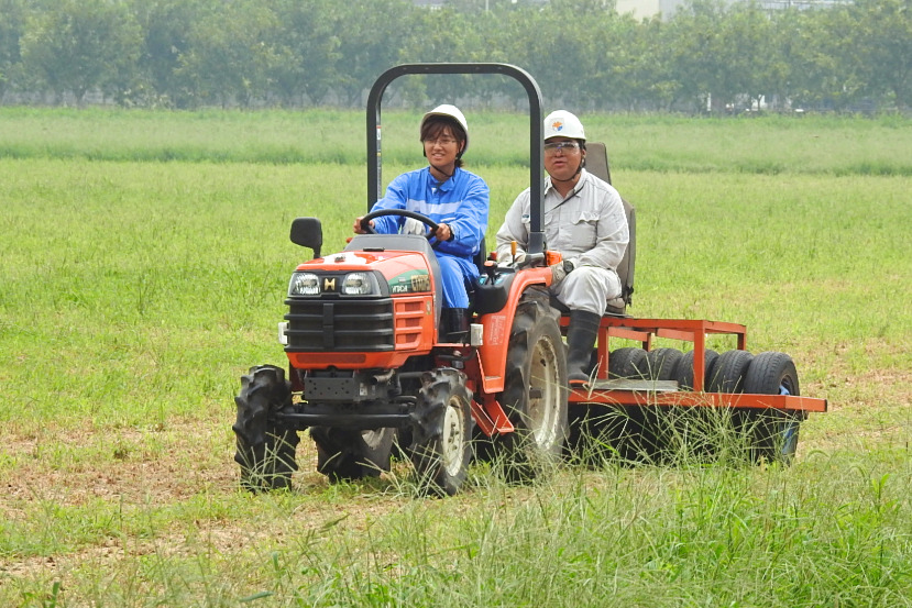 Two people on a tractor