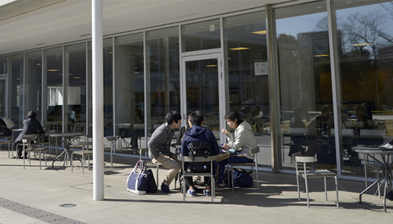 People sitting at a table outside a building