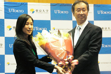 Professor Kajita receiving a bouquet of flowers from the University of Tokyo