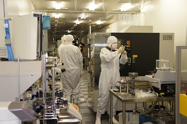 Attendees excitedly taking pictures and video in the Takeda Super Clean Room