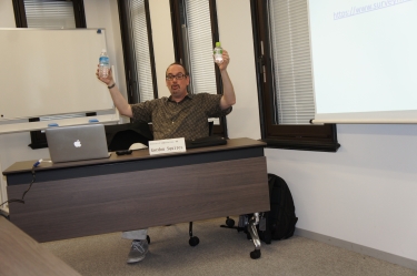 Dr. Squires likening his plastic water bottles to Pluto and its moon, Charon
