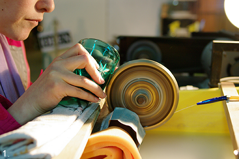 Fig. Artisan making kiriko glass in a workshop