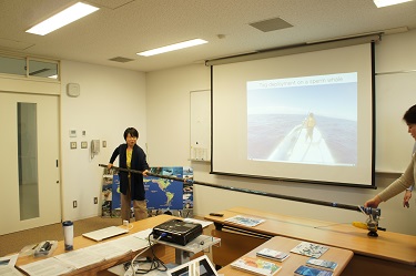 A member of Professor Sato's lab demonstrating how they tag whales with bio-logging devices