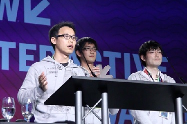 Xiaojun Sun, the leader of BionicM, giving an award acceptance speech on behalf of the team