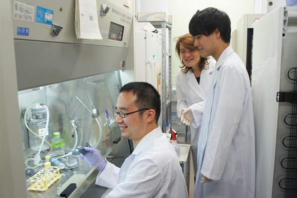 Researcher and students working in a lab