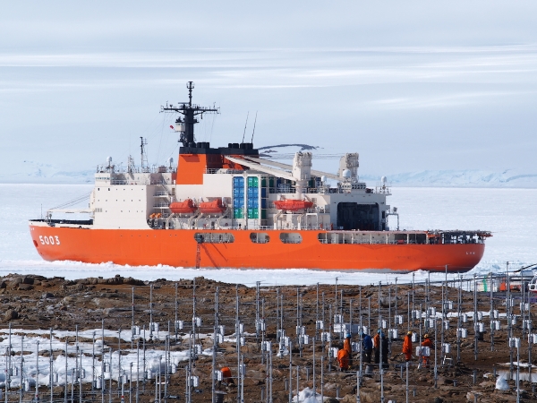 View of PANSY radar field with supply ship on the frozen water in the distance.