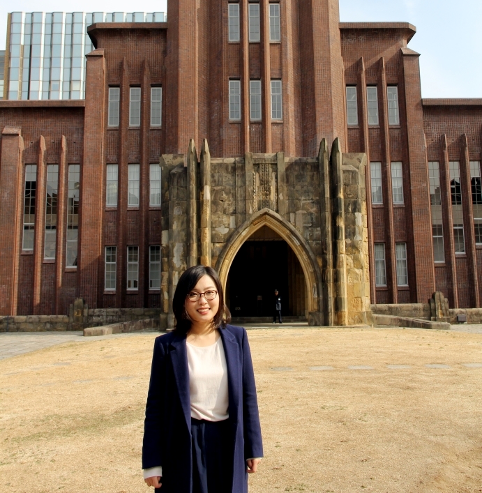 Student standing outside in front of a building