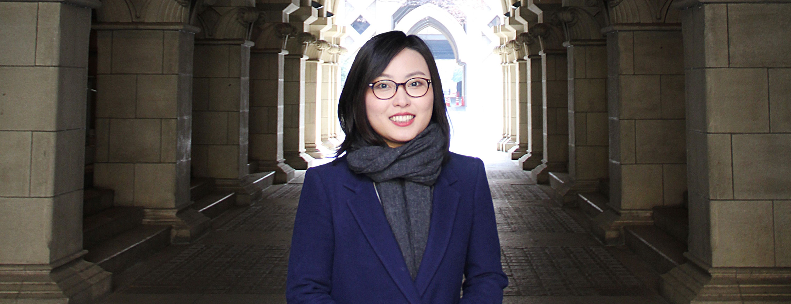 Student standing in an archway