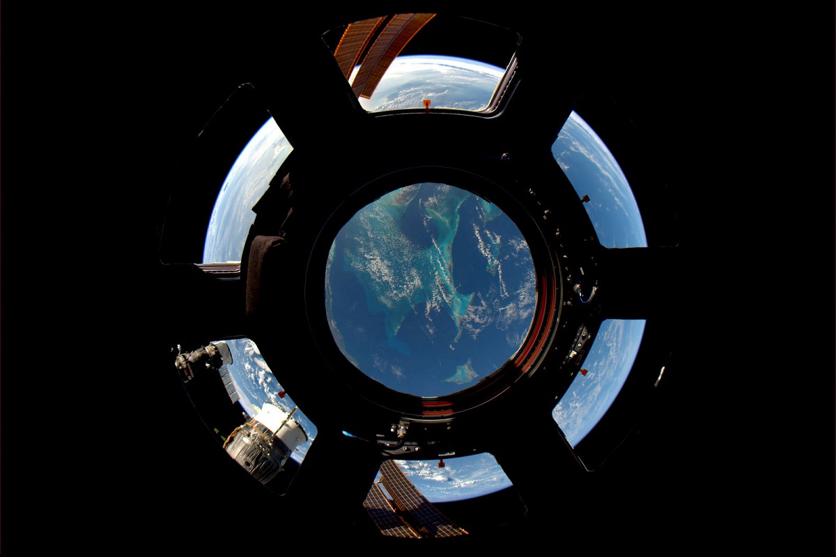 The windows of the International Space Station frame the Earth.