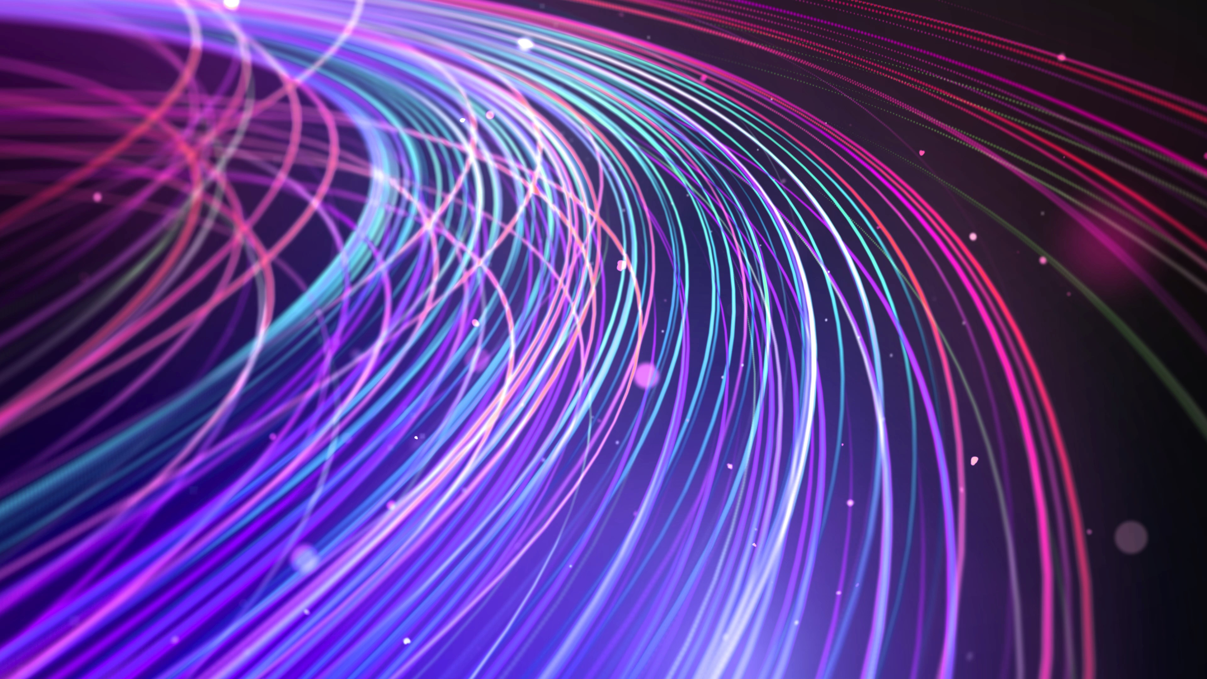 A dark background. A bundle of fibers colored purple, green and blue extend from the upper left to the lower right of the frame.