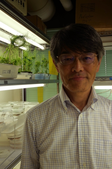 Portrait of man in an indoor botany research laboratory.