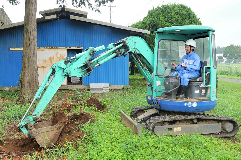 Person outside operating heavy machinery