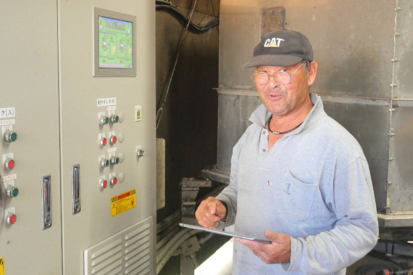 Man in front of control panel