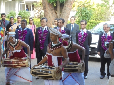 Parade led by students performing traditional drum and dance