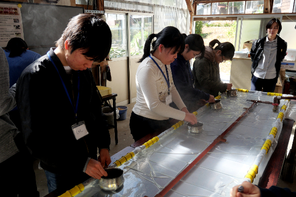 Students standing in front of a table