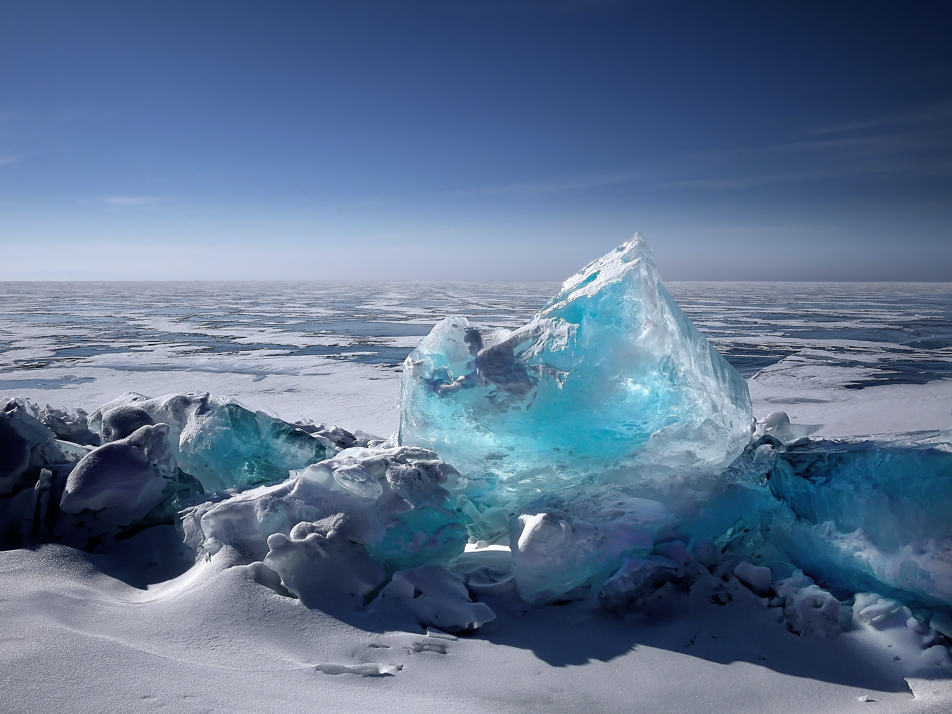 A clear ice block on a bed of snow