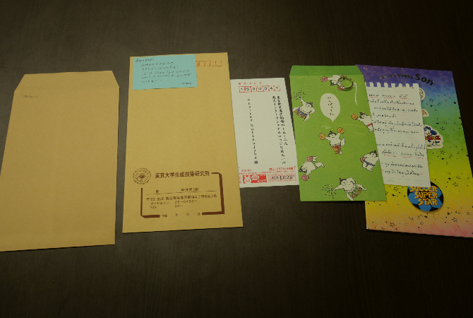 Paper cards and envelopes lined up on a table