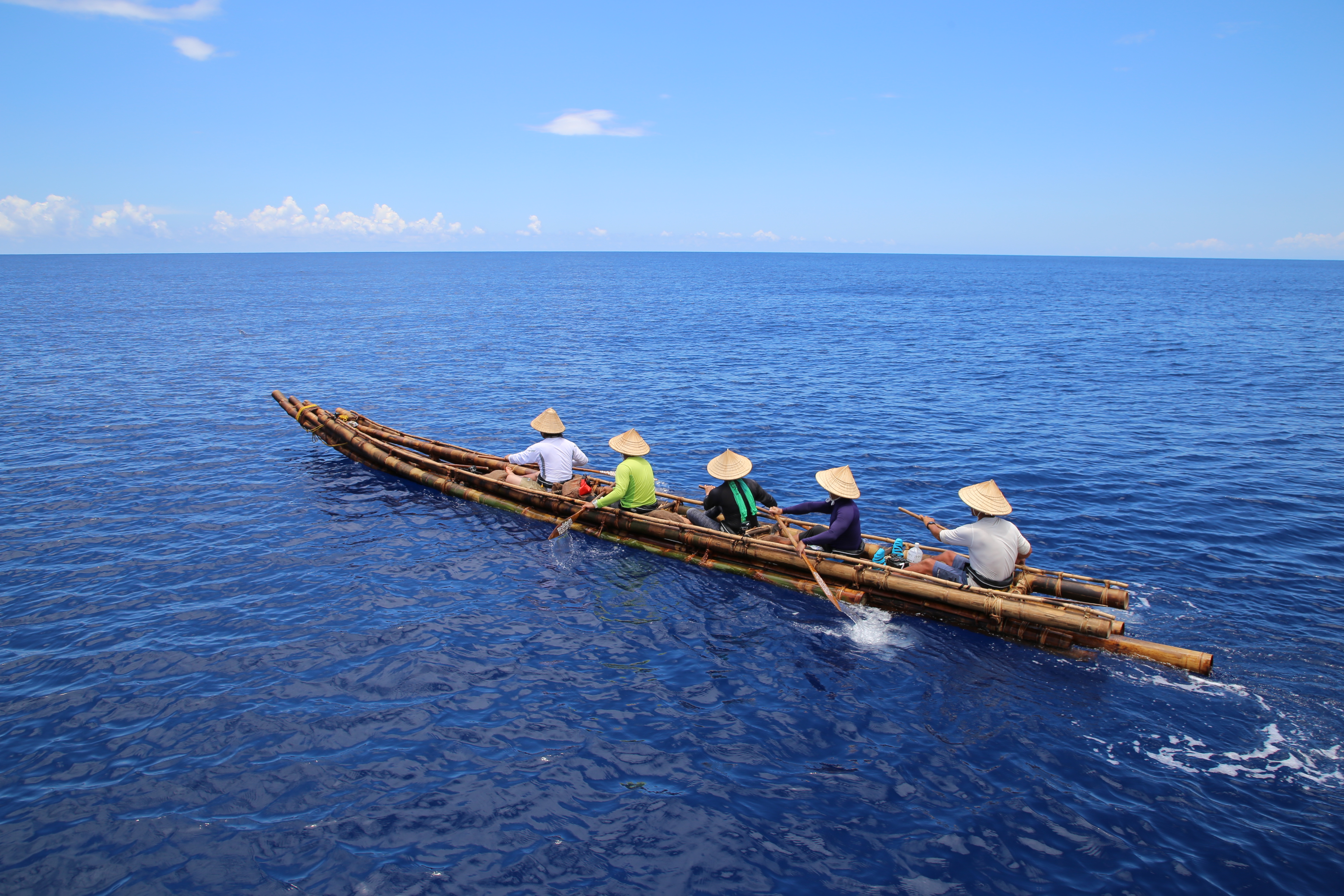 A simple wooden craft on a blue ocean