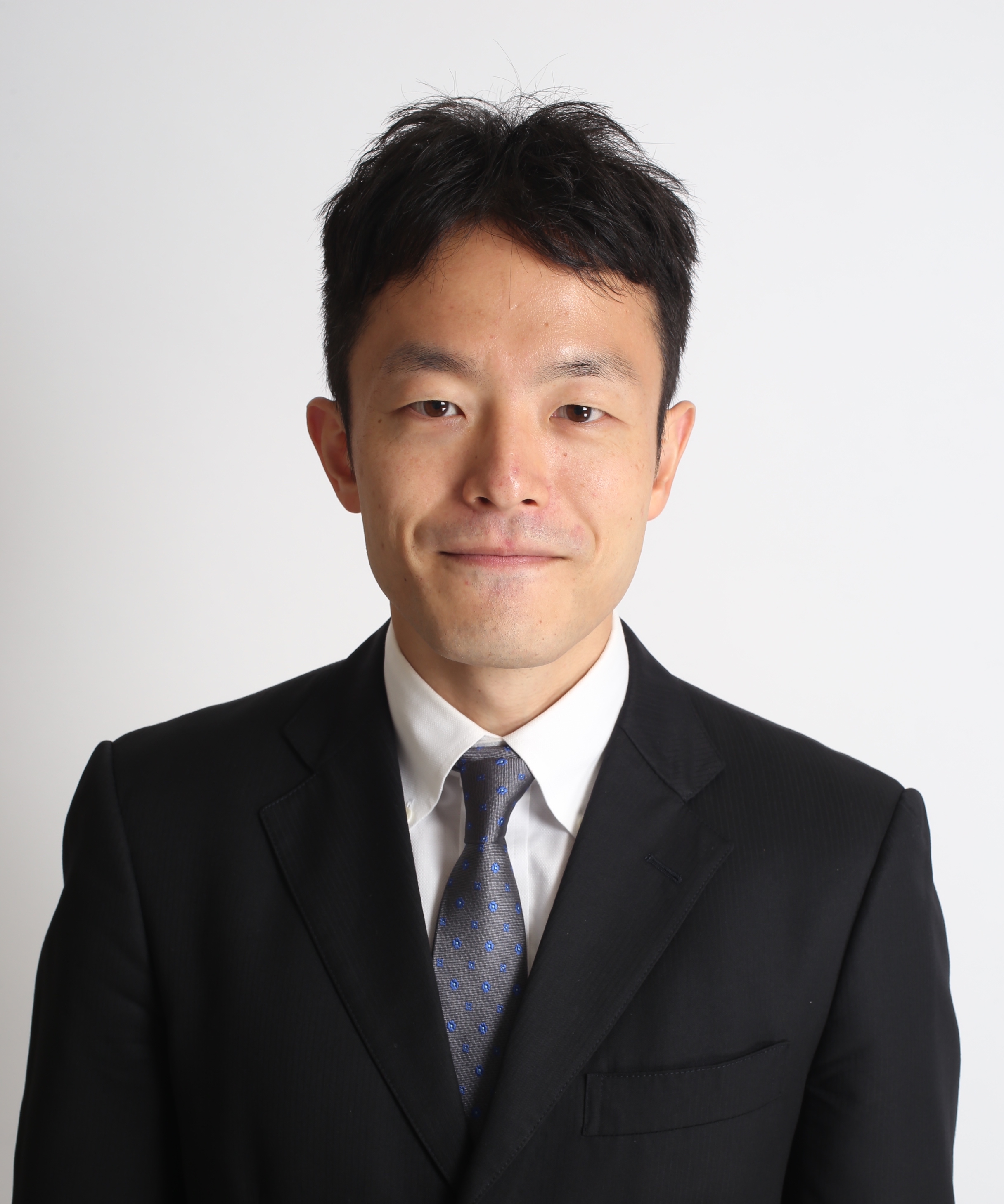 A man in a dark suit on a white background