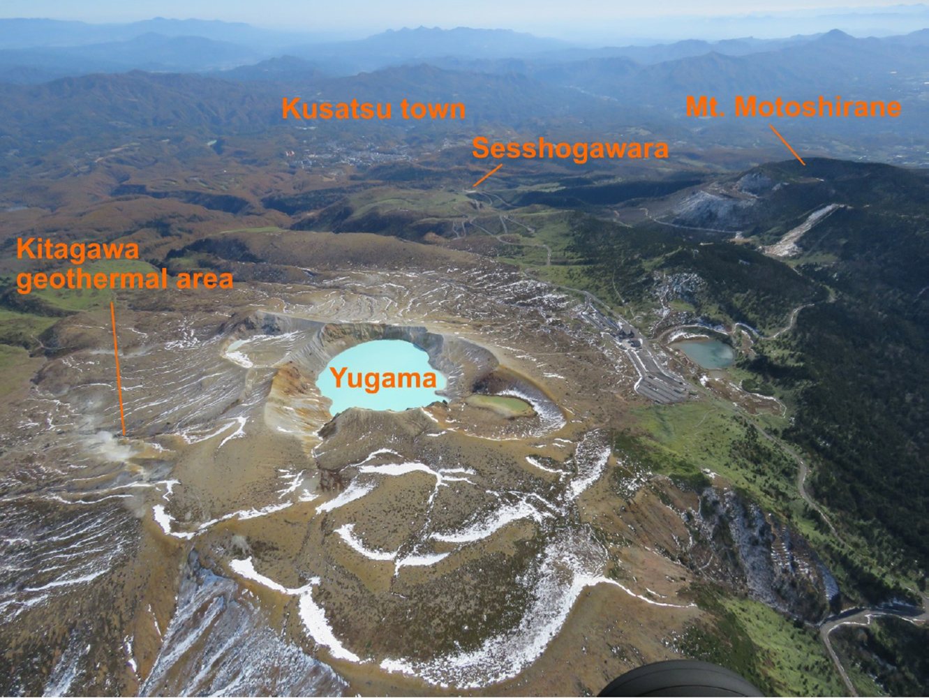 Aerial photo of the Kuaatsu-shirane volcano with some key locations, such as Kusatsu town, marked.