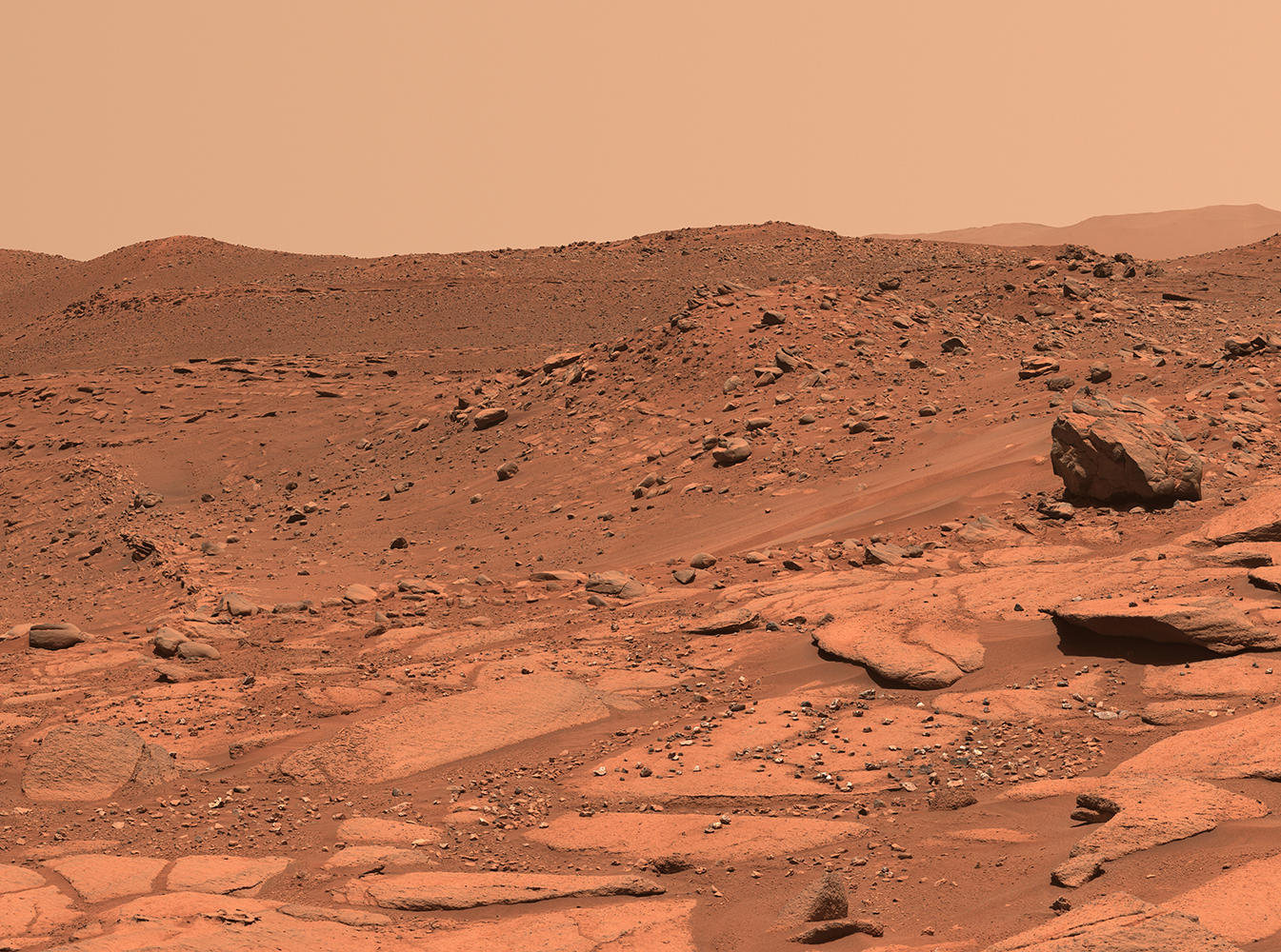 Image of Mars' rusty colored, dry rocky surface, taken by the Perseverance Rover.