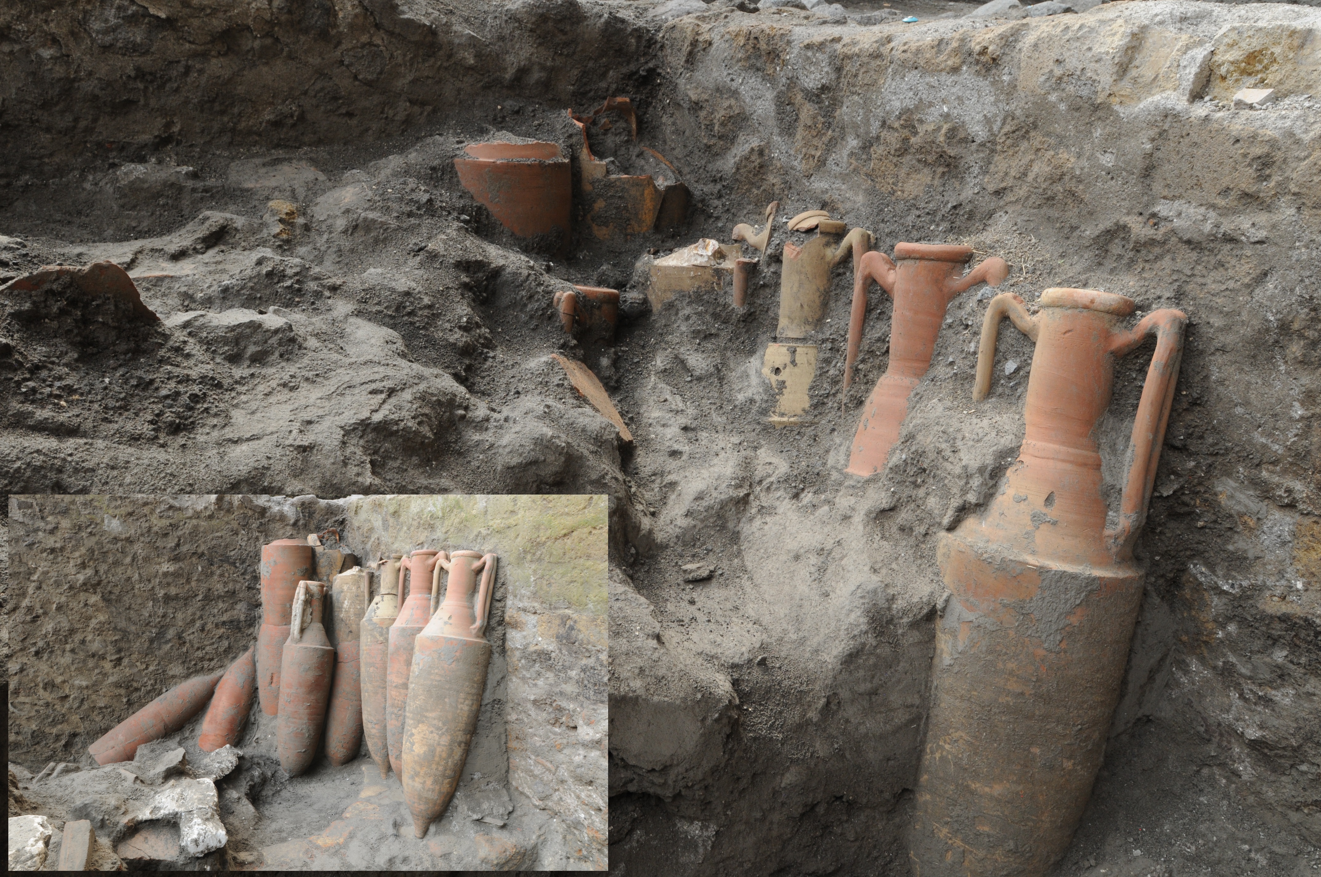 Large orange jars in a pit of dust