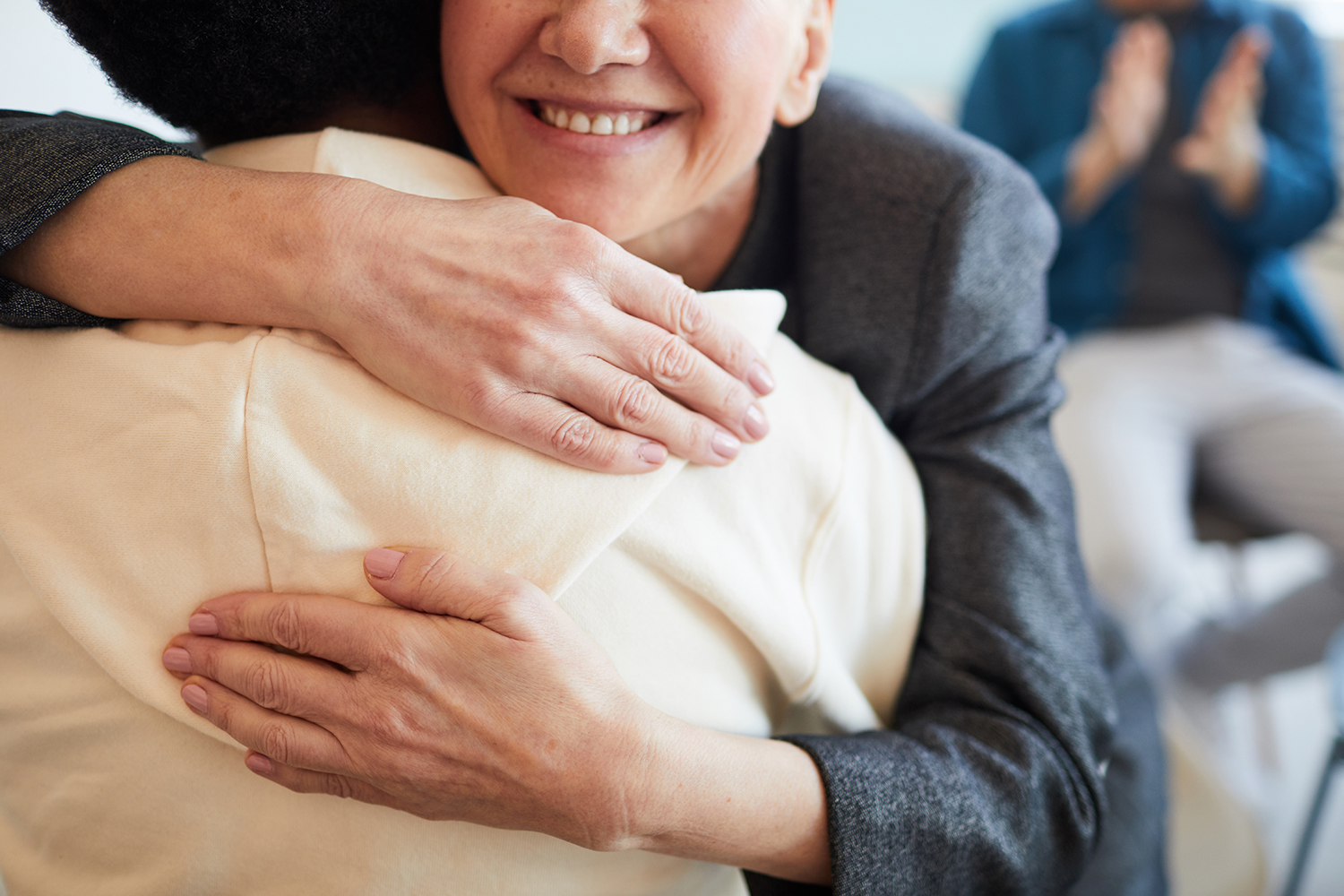 Photo of a close-up hug between two people.