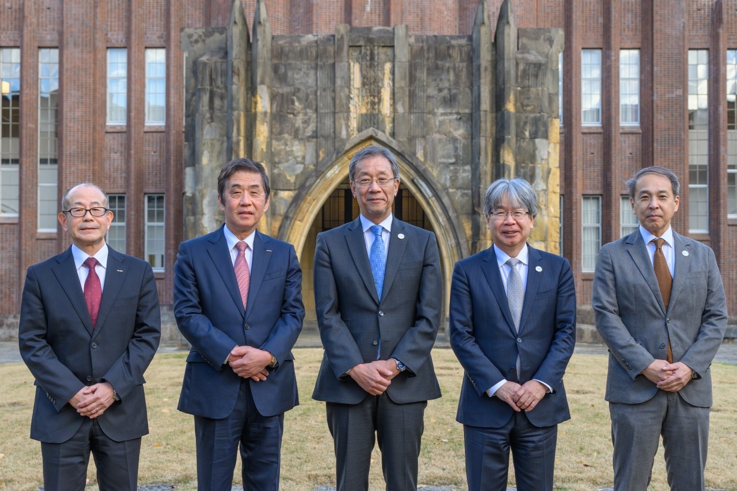 The speakers pose for a commemorative photo in front of Yasuda Auditorium