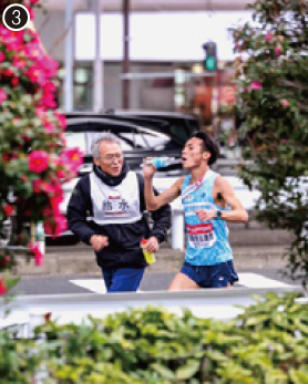 ❸ペットボトルの水を飲んで走る古川選手と八田先生が並走している様子